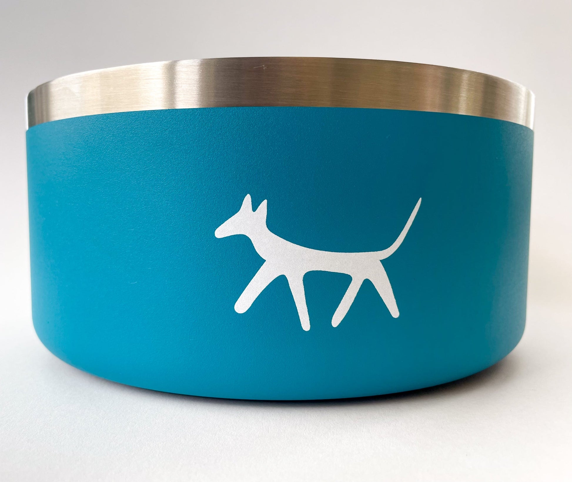 Close up of stainless steel dog bowl in lake colour with cream Droggo logo on the front. White background.