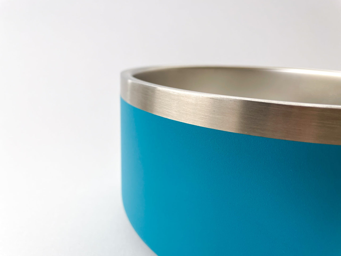 Close up of the stainless steel dog bowl in lake colour. White background.