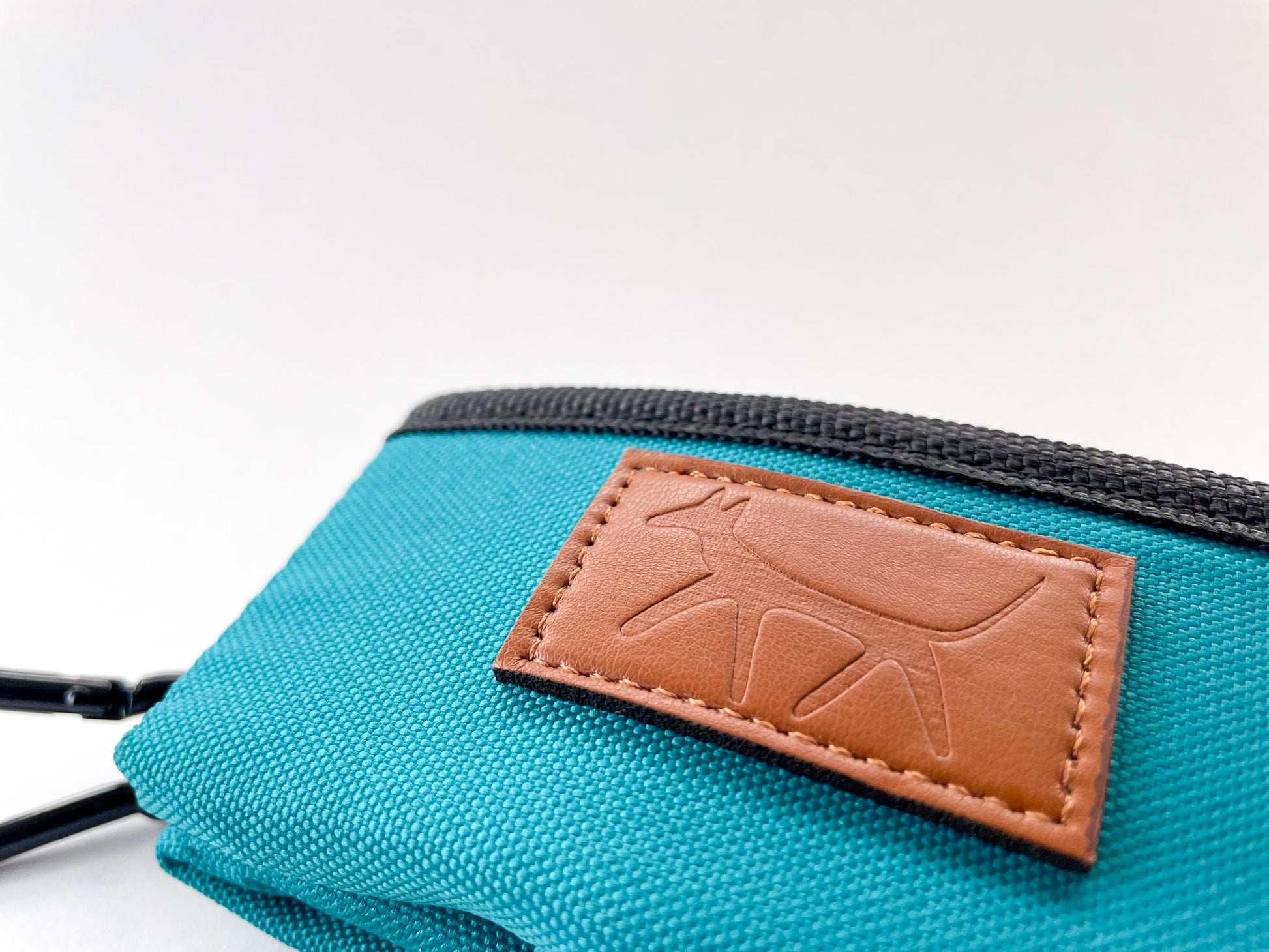 Detail of the leather Droggo logo on the dog travel bowl in lake colour.