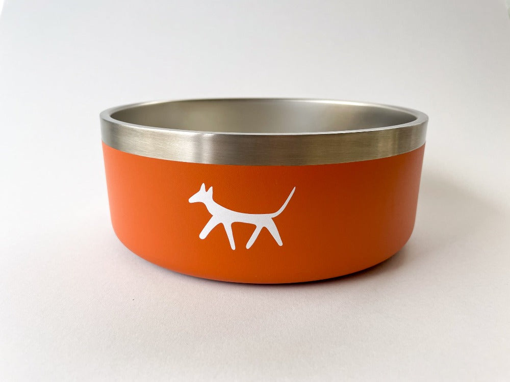 Stainless steel dog water bowl in rust colour with cream Droggo logo on the front. White background.