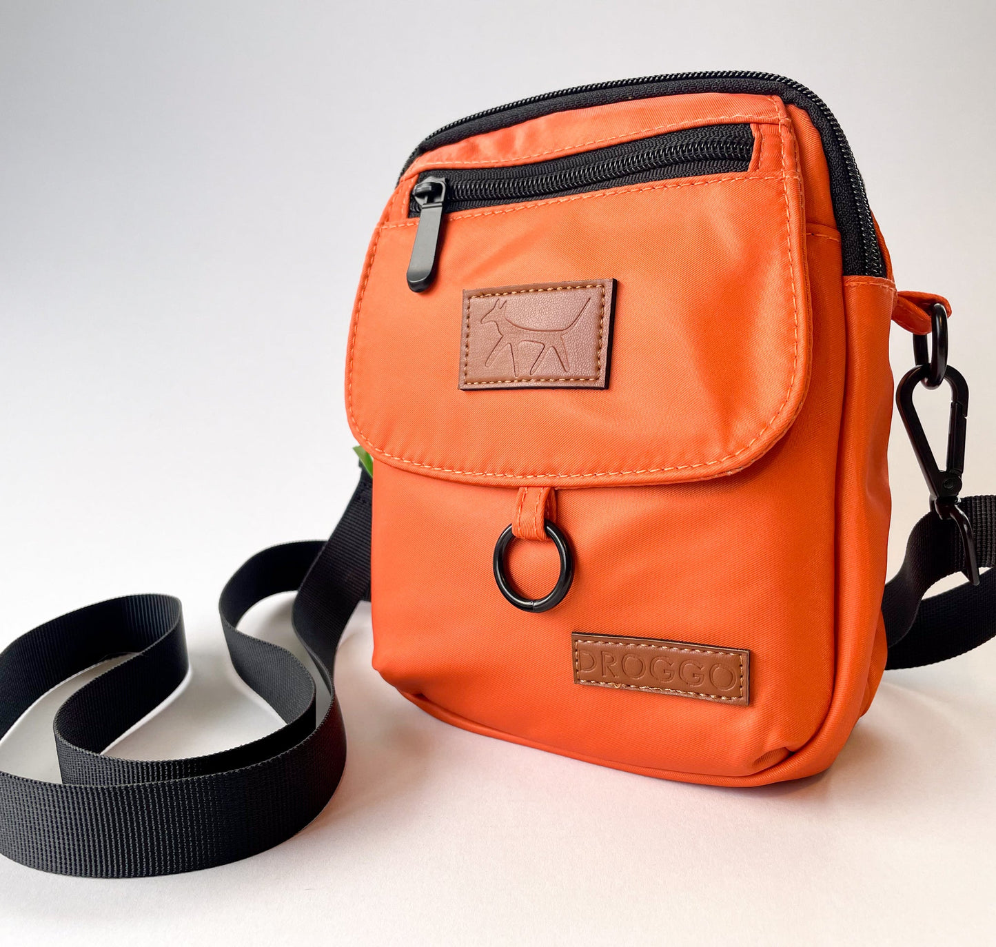 The dog walking bag in rust colour with leather Droggo logos on front. White background.